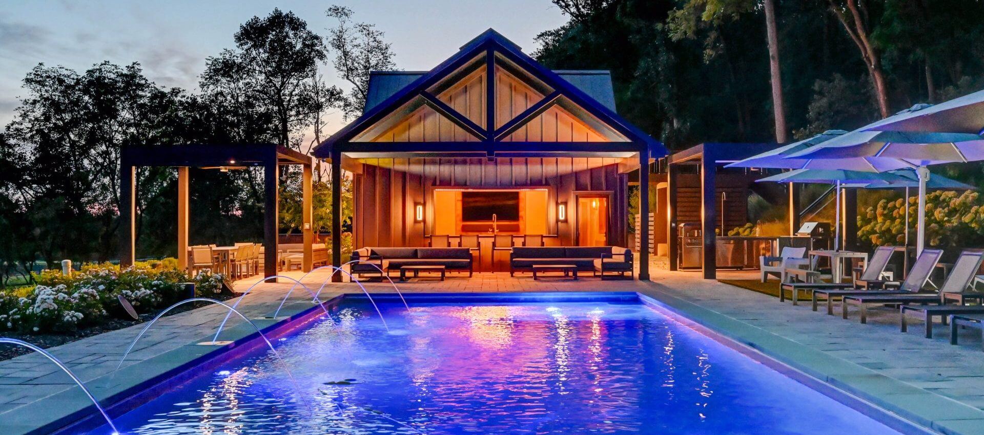 Pool house and pool at dusk